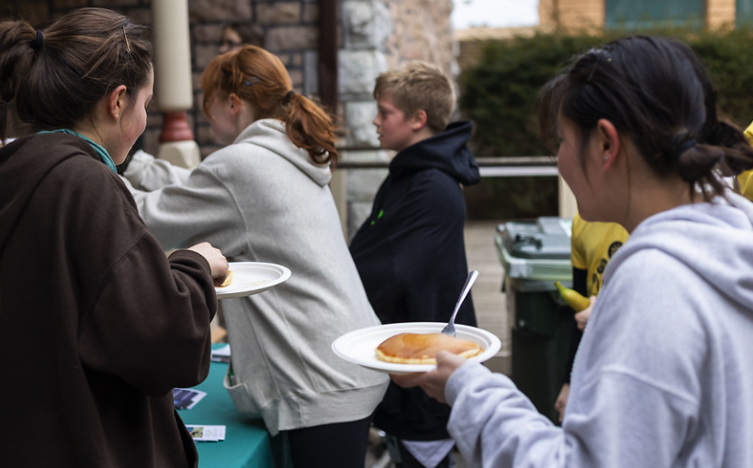 Maple Run runners in line to receive their pancakes after the 5k race at Rock Point School. 
