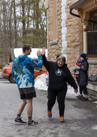 Maple Run runners congratulate each other at the end of the 5k race at Rock Point School